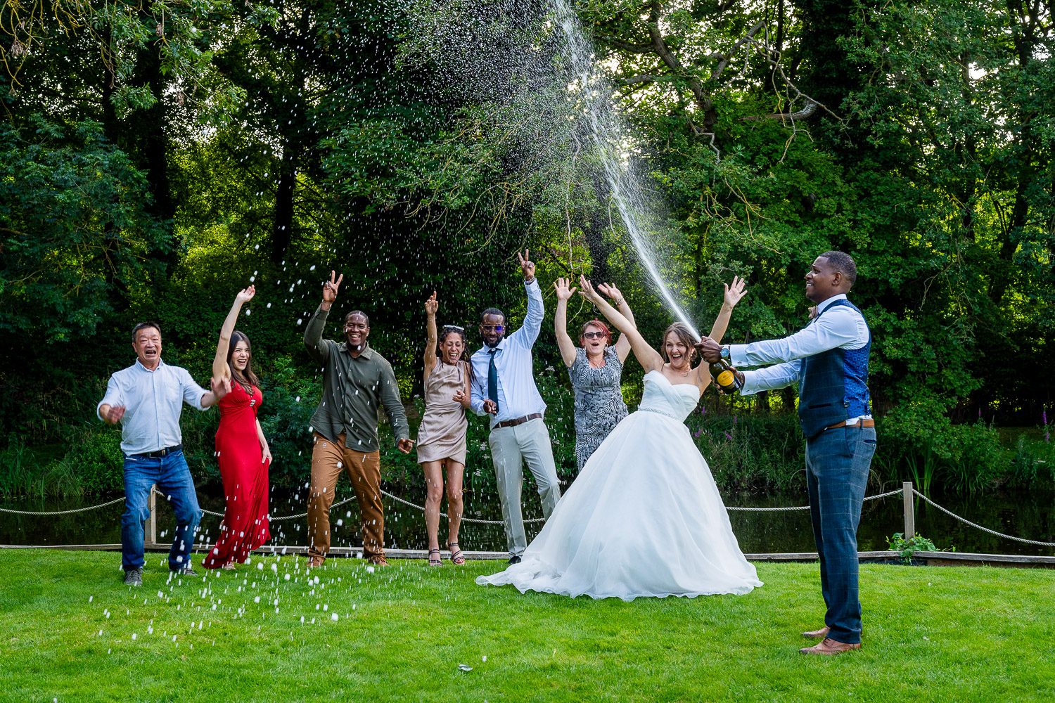 Bride and Groom having a Champagne spray at Sheene mill, Hertfordshire. Tim Payne Photography, a Hertfordshire wedding photographer.